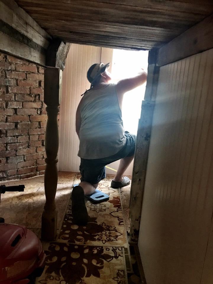 Owner (Ron) working on stairwell during refurbishment project