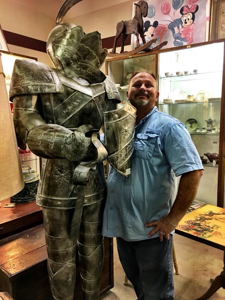Owner (Ron) antique shopping standing next to knight's armor